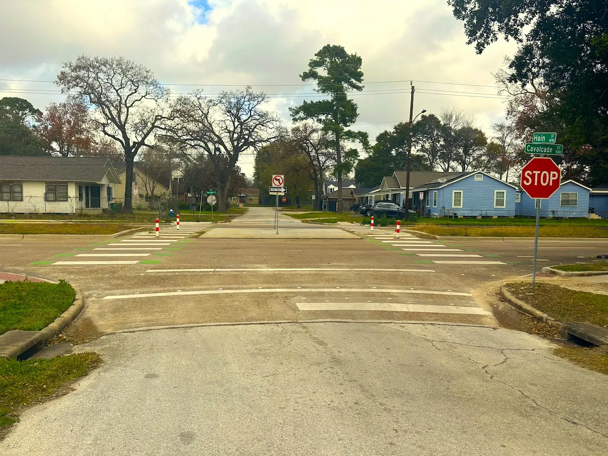A child riding a bike on a street